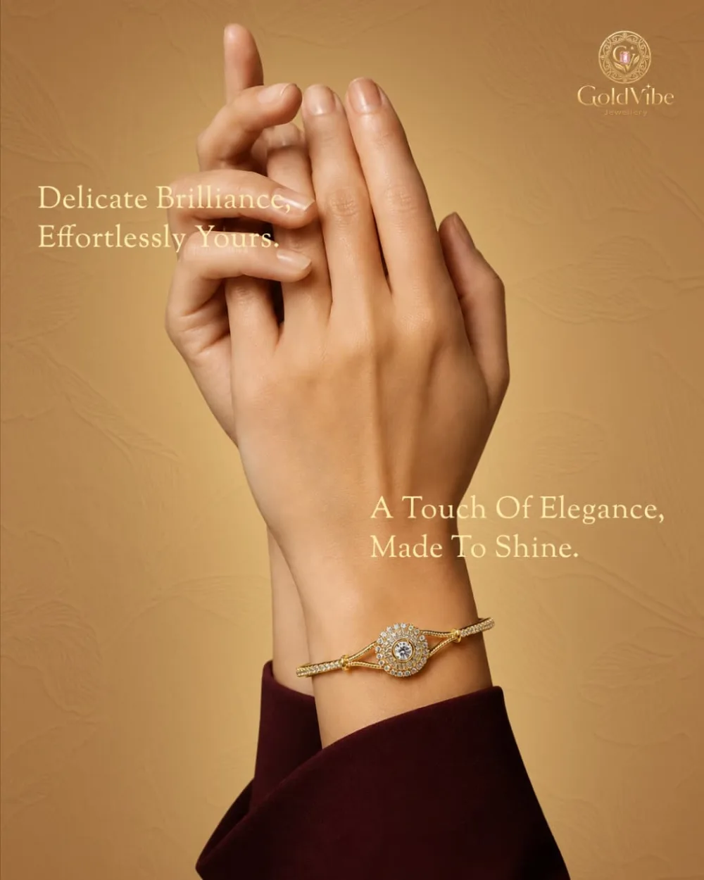 A GoldVibe bracelet with a round stone centrepiece on a raised wrist, against a warm honey ground.