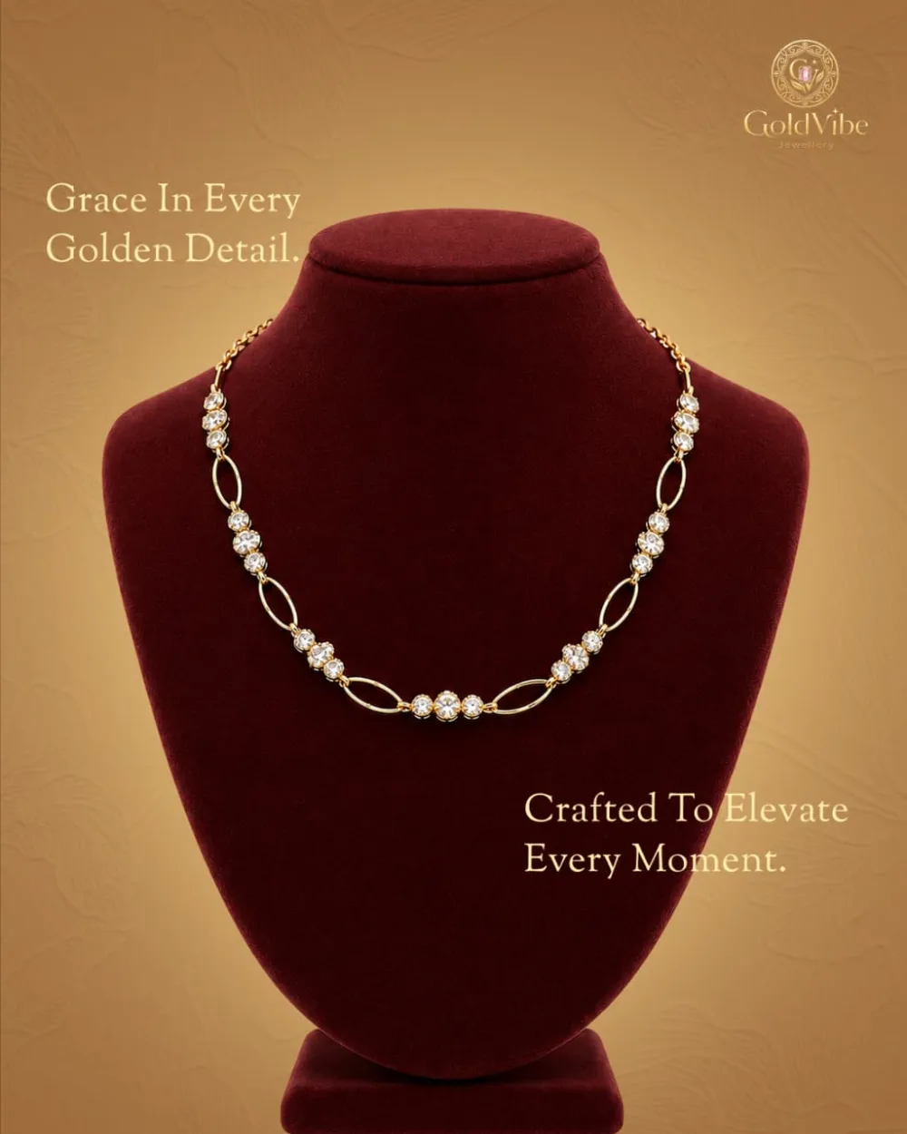 A stone-set GoldVibe chain necklace displayed on a maroon velvet bust.