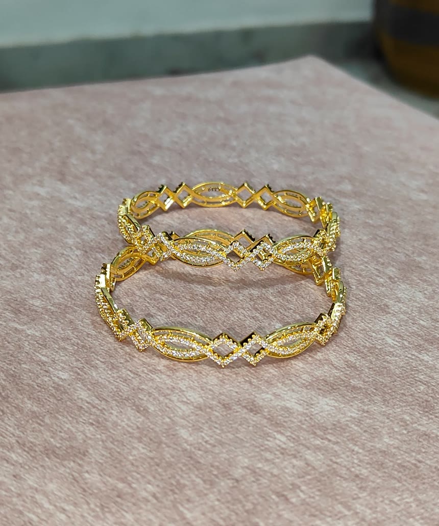 Pavé Bangle Pair — A matched pair, stone-set the whole way round — light on the wrist, festive on the hand.